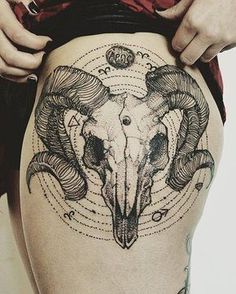 a woman's thigh with a ram tattoo on it