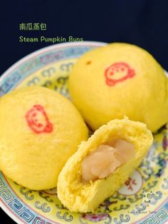 two steamed dumplings on a plate with chinese writing