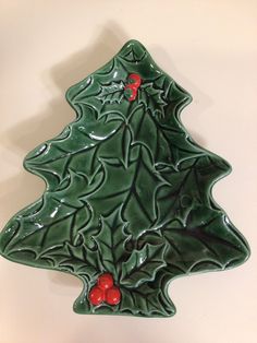 a ceramic christmas tree ornament hanging on a wall