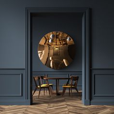 a dining room with a round mirror on the wall and two chairs in front of it