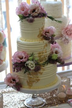 three tiered wedding cake with pink and white flowers