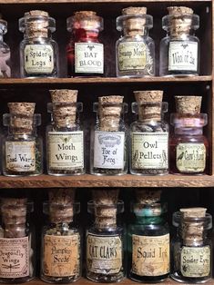 many different types of spices are on display in glass jars and wooden shelvings