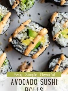 sushi rolls with avocado and sesame seeds on top