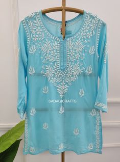 DESCRIPTION Kurti Fabric : Modal  Sleeves : 3/4 Sleeves Style : Short Top Length : 28-30 Inches Occasions : Casual Wear, Office Wear, Festive Wear Garment Care : Hand Wash Only Price Includes : 1x Kurti Fitted Blouse With Chikankari Embroidery In Straight Kurta Style, Traditional Blue Blouse With Chikankari Embroidery, Traditional 3/4 Sleeve Kurta For Diwali, Traditional Fitted Tunic With Chikankari Embroidery, Traditional Tunic With Zari Work For Festivals, Fitted Traditional Kaftan With Chikankari Embroidery, Traditional Kurta With 3/4 Sleeve For Eid, Traditional Fitted Tunic For Eid, Traditional Embroidered Kurta With 3/4 Sleeves