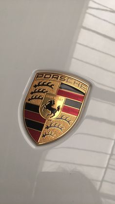 there is a porsche emblem on the side of a white car