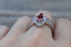 A Swoon-Worthy 2 Piece Bridal Ring Set features a Shimmery Teardrop Faceted 7mm x 5mm Garnet Halo Engagement Ring paired with a Garnet Contour Wedding Band handcrafted in your choice of metal such as Sterling Silver, Rose Plated/Gold Plated Silver or Solid 14k Gold is simply divine! Our Engagement Ring Set will have her swooned as it is a very unique ring set. It comes with a Ring Box ready for gift-giving. Engagement Ring Info ---------------------- Metal: Sterling Silver, Rose Plated/Gold Plat Wedding Pear-shaped Red Ruby Ring, Wedding Pear-shaped Ruby Ring, Teardrop Ruby Ring For Wedding, Red Teardrop Wedding Rings, Garnet Wedding, Contour Wedding Band, January Birthstone Rings, Curved Wedding Band, January Birthstone