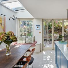 a kitchen with an island and skylight in the center, along with seating for four