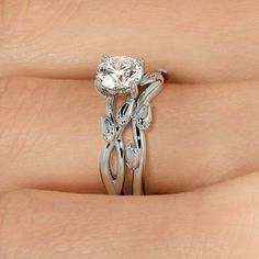 a woman's hand with two engagement rings on it