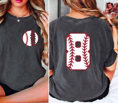 a woman sitting on top of a bed wearing a t - shirt with baseball stitches