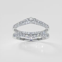 a white gold wedding ring set with two rows of diamonds on the band and an open diamond