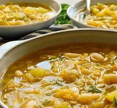 two bowls filled with soup sitting on top of a table