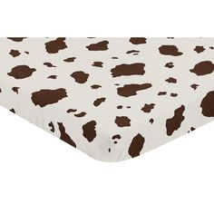 a brown and white cow print crib sheet