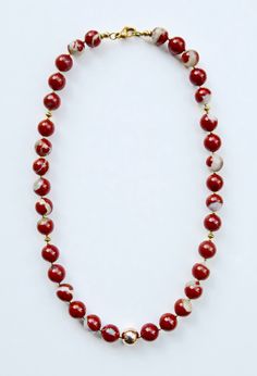 Necklace made of red jasper with agate inclusions:  Between the jasper beads sit tiny golden beads and rings, the middle of the necklace is particularly emphasized by a golden bead. The two ends of the necklace are decorated and secured with golden rings and beads. Including the stylish and secure lobster clasp, everything is handcrafted in goldfilled metal (see FAQ). The jasper beads have diameters of approx. 11 mm, the golden bead have a diameter of approx. 10 mm. The necklace is approx. 44. 5 Red Jasper Necklaces, Red Jasper Necklace, Golden Rings, Golden Beads, Jasper Necklace, Golden Ring, Stainless Steel Wire, Jasper Beads, Red Jasper