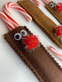 some candy canes with googly eyes on them next to peppermint sticks