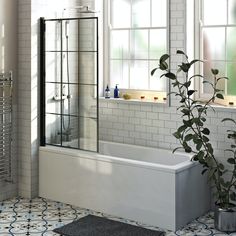 a bathroom with a tub, shower and window