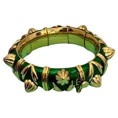 Stunning Tiffany & Co. Schlumberger Cone Losange Bracelet, crafted in 18k yellow gold and enriched with vibrant Green enamel, accented with alternating clusters of gold leaves and cone shape gold structures, separated by gold rings. The bracelet measures about 16 mm in wide . This bracelet is one of the widest and the heaviest one . 18 K gold is 138 grams. Since 1956 Jean Schlumberger has collaborated with Tiffany and Co. to create some of the worlds most coveted and fashionable jewelry. Inspire Giorgio Visconti Bracelet, Jean Schlumberger, Tiffany And Co Bracelet, Enamel Bangle, Feuille D'or, Green Fits, Fashionable Jewelry, Gold Leaves, Tiffany And Co