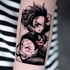 a woman's arm with two anime characters on it