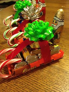 some candy bars wrapped in green and red ribbons