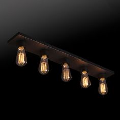 an image of a light fixture with five bulbs hanging from it's side on a black background