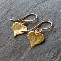 Sweet hammered gold heart earrings.  These lovely vermeil hearts are lightly hand hammered to add  texture and catch the light a little.  With 'fits snug to ear' 14kt gold fill hooks.   Hammered on front only. Dainty, lightweight and easy to wear.  Why not grab these little beauties for a loved one?  Also in rose gold - https://etsy.me/36M8W3H Also in sterling silver - https://etsy.me/36NhN5l More heart jewelry - https://etsy.me/2Rp7ChM * Length overall is about 2cm (2/3 inch)  * Vermeil heart 1 Gold Heart Earrings, Romantic Earrings, Gold Heart Earring, Mum Birthday Gift, Gold Dangle Earrings, Silver Coat, Gift For Mum, Jewelry Birthday, Hammered Gold