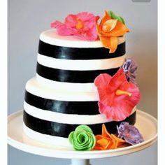 a black and white striped cake with flowers on top