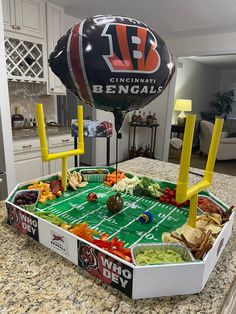 an inflatable football and some snacks on a table with a large balloon attached to it