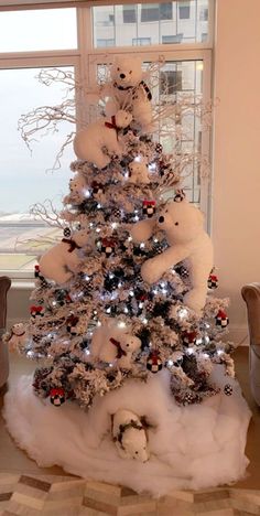 a white christmas tree decorated with teddy bears