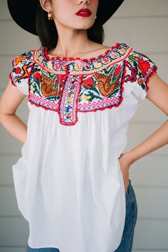 "This vintage Mexican hand embroidered cross stitch blouse is made from lightweight cotton with beautiful crochet birds and floral cross stitch in color mix. Condition: In Very Good Vintage Condition **small brown spot under the bust (front) 3 small spots (back) shown in the last picture Details and Measurements (Inch) size estimate: L *Measurements are taken in inches with the garment laying flat. BUST: 40 \" FULL LENGTH: 27.5 \" SLEEVES LENGTH: 3.5\" Material = cotton, cross stitch, crochet Ou Cross Stitch Crochet, Mexican Peasant Blouse, Floral Embroidery Top, Traditional Mexican Dress, Cotton Gauze Dress, Embroidered Cross, Mexican Blouse, India Dress, Crochet Birds