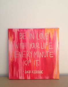 a pink painting with white writing on it that says be in love with your life every minute off it