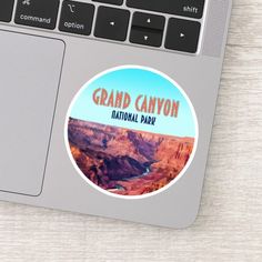 the grand canyon national park sticker is on top of a laptop keyboard and mouse