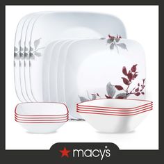 the red and white dishes are stacked on top of each other, with leaves painted on them