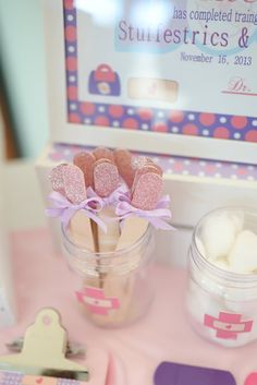 there is a jar with some candy in it on the table next to other items