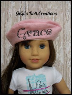 a doll wearing a pink hat with the word grace written on it's side