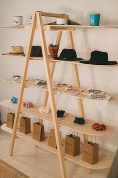 a wooden shelf with hats and bags on it