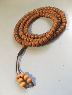 Nepal Bodhi Seed Mala with Sandalwood end beads and an adjustable knot. 108 bead necklace with Phoenix Eye guru bead for Japa Mala Holistic Wooden Beads Mala For Festivals, Adjustable Brown Mala For Healing, Hand-strung Adjustable Mala For Festivals, Adjustable Hand-strung Mala For Festival, Adjustable Brown Mala For Festival, Holistic Brown Mala With Wooden Beads, Holistic Wooden Beads For Festivals, Adjustable Mala With 8mm Beads For Festivals, Brown Wooden Beads Spiritual Mala