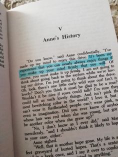 an open book with the words anne's history written in blue and green on it