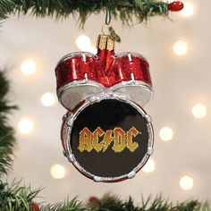 a christmas ornament with the word ac dc on it hanging from a tree