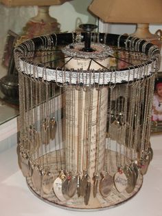 a table topped with lots of silverware next to a mirror