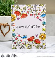 a mother's day card on a table next to a potted plant