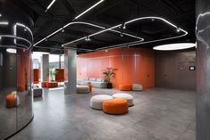 an empty office with orange and white furniture