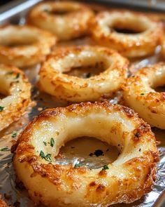 some onion rings are sitting on tin foil