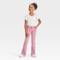 Add a colorful staple to your kid’s closet with these Button Fly Flare Jeans from Cat & Jack™. Made from midweight cotton-rich fabric with stretch, the regular-fit jeans are designed with a bootcut-leg silhouette for flowy, comfortable wear. The adjustable waistband with belt loops and distinct four silver-finish fly buttons offers a secure fit, and the classic five-pocket style adds functional flair. Plus, they'll love the pink finish that adds a pretty look to any outfit, as well as the cool, Cute Cotton Bottoms With Buttons, Jeans For Kids, Style Flare Jeans, Flare Jeans Outfit, Rich Fabric, Adjustable Waistband, Hem Style, How To Style, The Cool