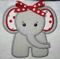 an elephant with a red bow on its head