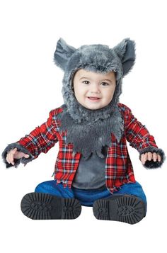 a small child wearing a costume with an animal hat on it's head and legs