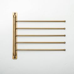 four brass - plated rods on a white background