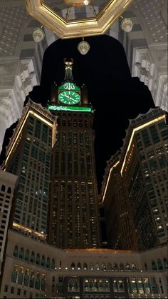 the clock tower is lit up at night in the city's grand central area