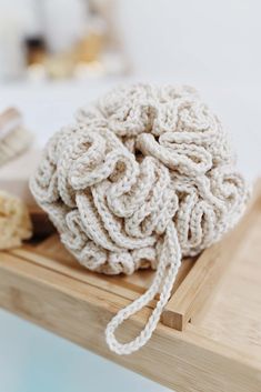 a white ball of yarn sitting on top of a wooden table next to other items