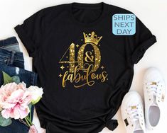 a t - shirt with the words 80 and fabulous on it next to some flowers