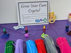 there is a sign that says grow your own crystal on the table next to it