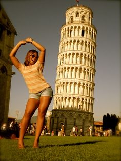 a woman posing in front of the leaning tower